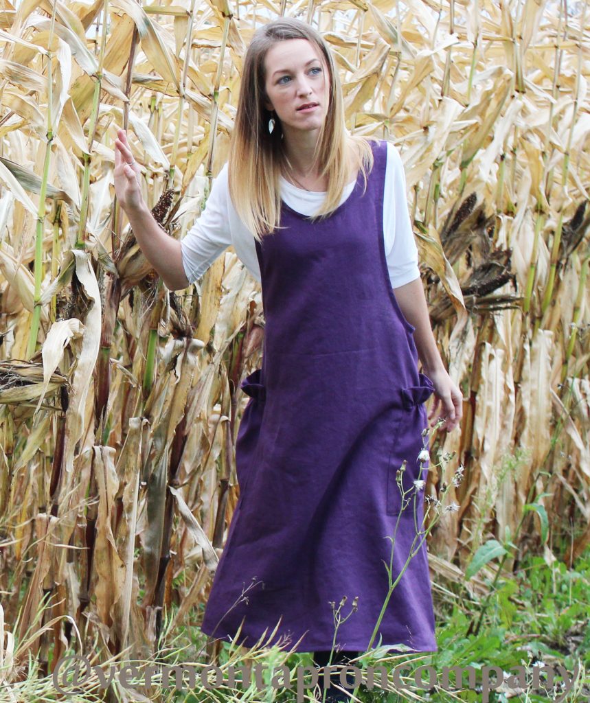deep purple linen aprons with criss cross straps and big ruffled pockets.